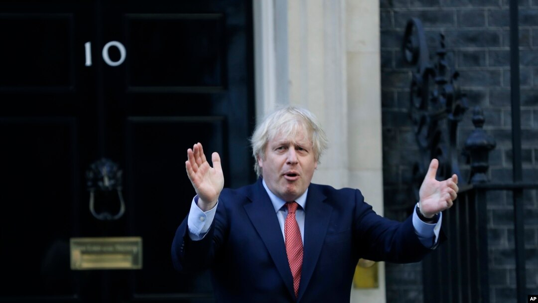 Britain's Prime Minister Boris Johnson applauds on the doorstep of 10 Downing Street in London during the weekly "Clap for our Carers", May 28, 2020. 