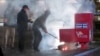 A still image from a video shows first responders pulling out the burning contents of a ballot box after it was set on fire in Vancouver, Washington, on Oct. 28, 2024. (Evan Bell/ABC Affiliate KATU via Reuters)