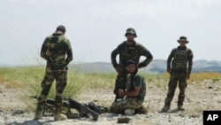 FILE - Afghanistan's National Army soldiers take positions in Khogyani district, in Nangarhar province, east of Kabul, Afghanistan. 