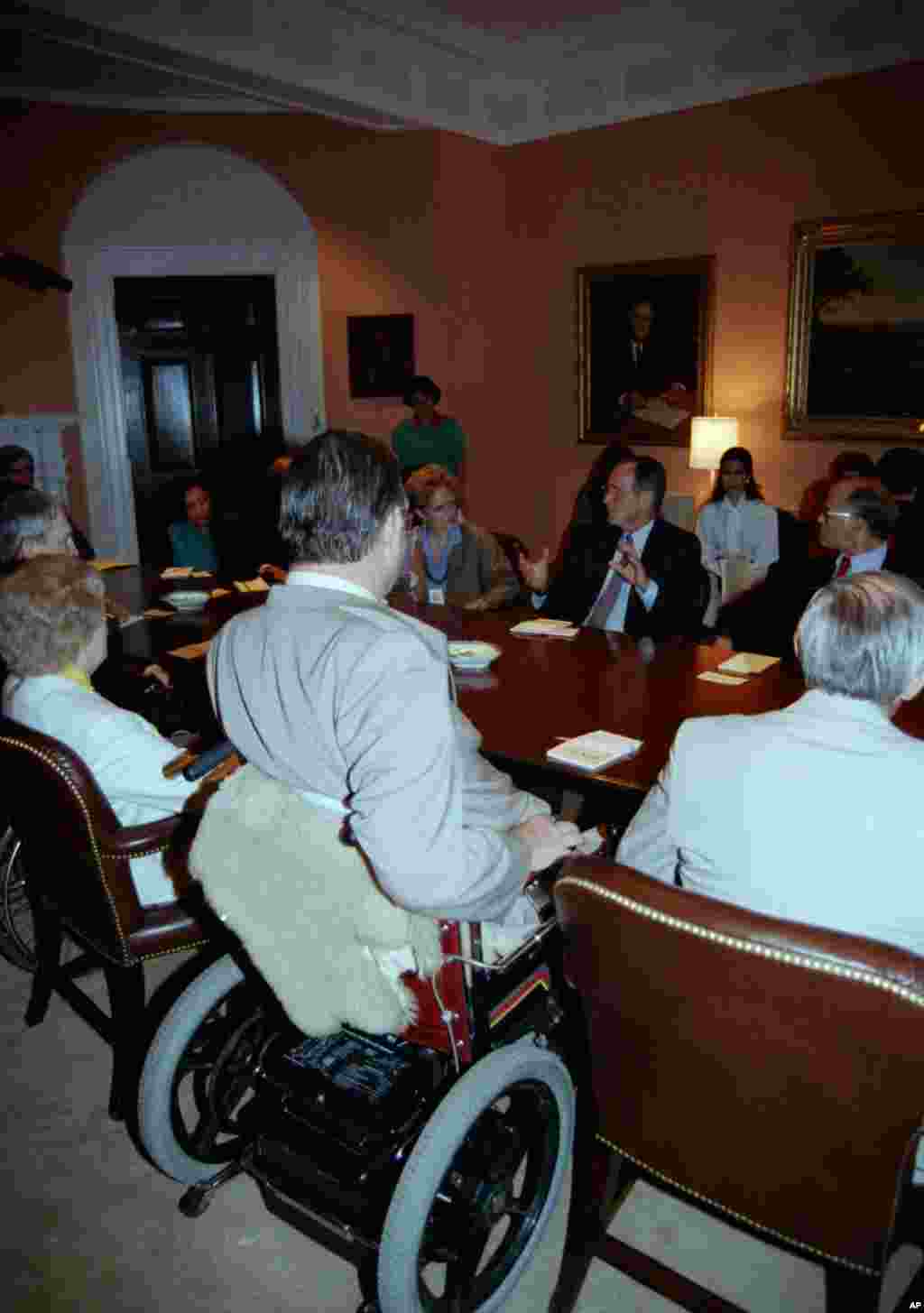 President George H.W. Bush meets with disabled community leaders at the White House in Washington, D.C., to discuss the Americans With Disabilities Act on Aug. 11, 1989.