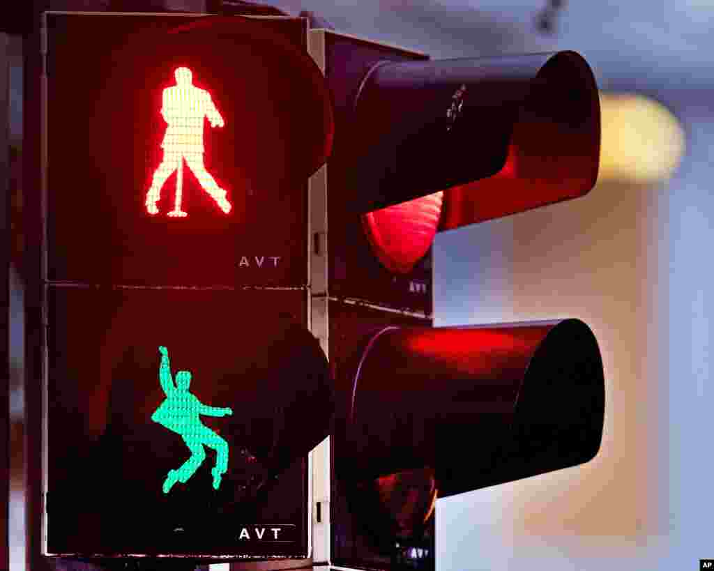 Walking figures depicting late US rock and roll legend Elvis Presley appear on a traffic light switching from green to red in Friedberg near Frankfurt, Germany, Dec. 6, 2018.