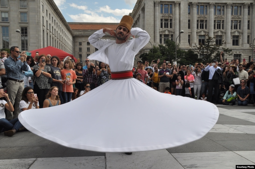 Khaled Moulawi, previously a member of the Damascus Arts Association, dances an ancient whirling dervish dance at the Syria Fest on Freedom Plaza in Washington, Sept. 3, 2017. (Photo courtesy of Rabah Seba)