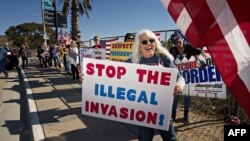 FILE - Demonstrators chant during an "America First" rally at the San Ysidro Port of Entry along the U.S.-Mexico border in San Ysidro, Calif., Dec. 15, 2018.