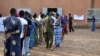 People wait in line to cast their ballots in a polling station in Ouagadougou during Burkina Faso's legislative and municipal elections, December 2, 2012. 