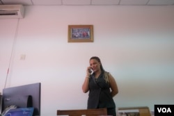Suzy Carla Barbosa, parliament member and second vice president for the PAIGC part in Guinea Bissau, talks on the phone in her office, Dec. 14, 2017. (R. Shyrock)
