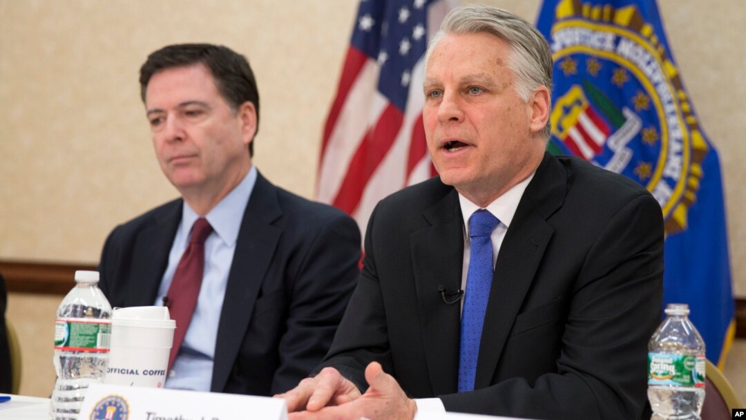 FBI Director James Comey, left, joins Timothy Roemer, a 9/11 Review Commission member and former congressman, at a news conference at FBI headquarters in Washington, March 25, 2015.