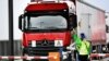 Ferry terminal workers from the Brexit info-team give a flyer to a truck driver to review that cargo can be transported quickly via Dutch ports after the Brexit, in Vlaardingen, Netherlands, March 13, 2019.