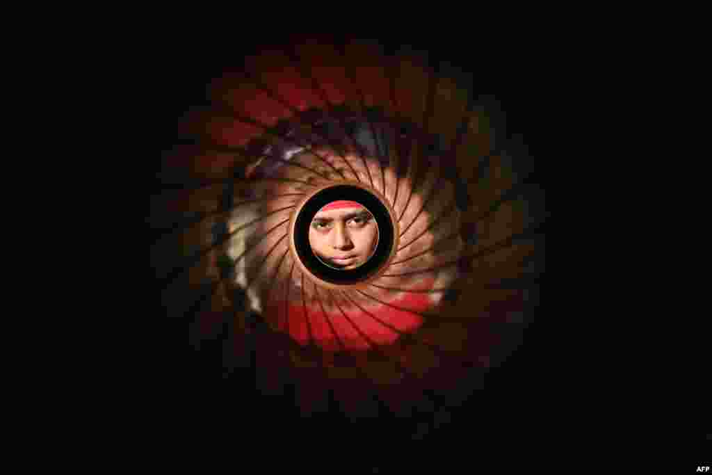 A student looks through an army anti-tank rocket launcher during the &quot;Weapon and Equipment Display&quot; exhibition organized by the Indian Army as part of &quot;Vijay Diwas&quot; celebrations, at the Punjab State War Heroes Memorial and Museum in Amritsar.&nbsp;