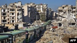 Buses are seen during an evacuation operation of rebel fighters and their families from rebel-held neighborhoods in the embattled city of Aleppo on Dec. 15, 2016.