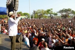 Kenyan opposition leader Raila Odinga addresses supporters during a rally in Mombasa, Kenya, Oct. 15, 2017. Odinga, who has taken himself out of the running, has called for a mass rally on Oct. 26 if a presidential re-run vote is held that day.