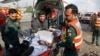 FILE - Pakistani rescue workers remove a body from the site of a deadly bombing in the eastern city of Lahore, Pakistan, July 24, 2017. 