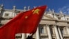 FILE - A pilgrim waves a Chinese flag during Pope Francis weekly general audience in St. Peter square at the Vatican, Nov. 22, 2017.