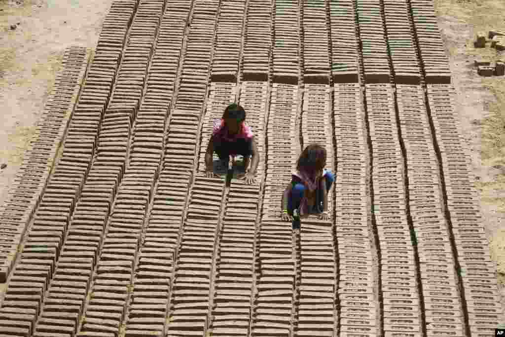 Indian children work at a brick factory on the outskirts of Jammu, May 1, 2018.