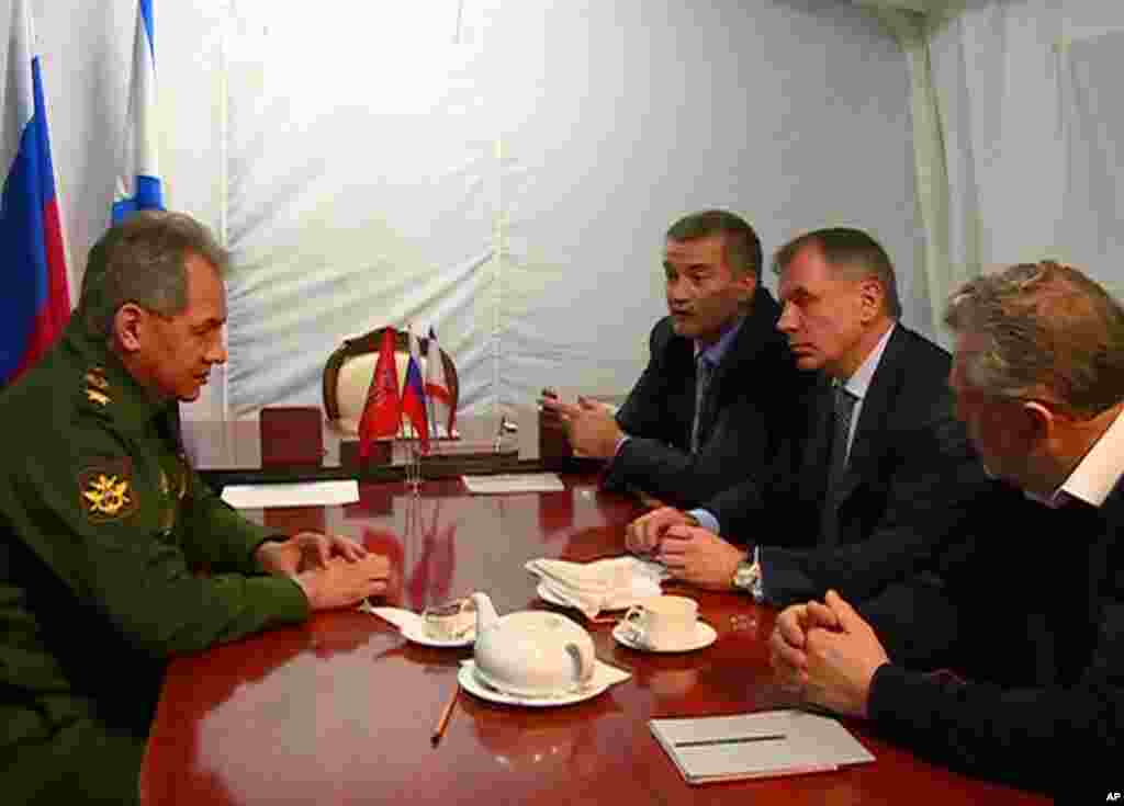  Russian Defense Minister Sergei Shoigu meets with, from left, Crimean Prime Minister Sergei Aksyonov, Speaker of Crimean legislature Vladimir Konstantinov and Sevastopol mayor Alexei Chalyi at a military base in Sevastopol, Crimea, March 24, 2014.