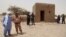 People attending a ceremony stand near a mausoleum that was restored in Timbuktu, Mali, July 18, 2015. 