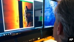 Rob Kraft, director of undersea operations at Vulcan Inc., reviews sonar scans of a warship from the World War II Battle of Midway that was found by the crew of the research vessel Petrel on Sunday, Oct. 20, 2019 off Midway Atoll.