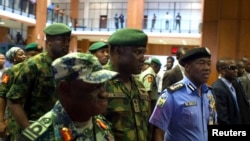 FILE - Nigerian Gen. Kenneth Minimah and guards leave a meeting in Abuja, May 15, 2014.