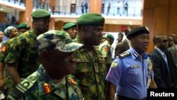 FILE: Nigerian mlitary officials are consulting with Sri Lanka on tactics that country used to overcome terrorists. Here, Nigerian Gen. Kenneth Minimah and guards leave a meeting in Abuja on May 15, 2014.