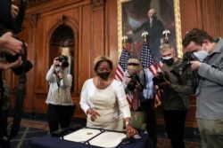 Latrice Powell, deputy floor director of the U.S. House, lays down pens and the article of impeachment against U.S. President Donald Trump, which House Speaker Nancy Pelosi was set to sign, at the Capitol in Washington, Jan. 13, 2021.