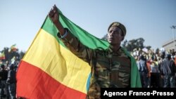 A man in military suit holds an Ethiopian flag during a rally in Addis Ababa, Ethiopia, on Nov. 7, 2021, in support of the national defense forces.