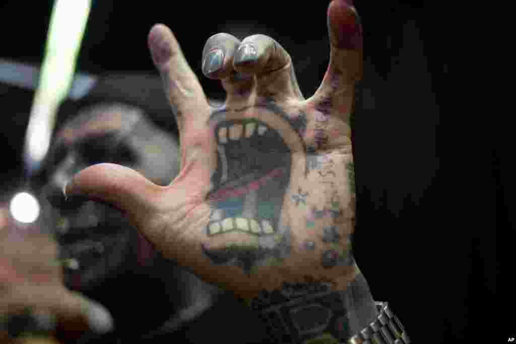 Magneto of Berlin Germany shows his tattoos for a photograph during the Israel Tattoo Convention in Tel Aviv, Israel. Around 140 tattoo artists from around the world participate in a two-day fair.