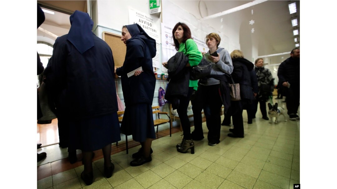 People line up at a polling station near the Vatican, in Rome, March 4, 2018.