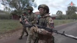 FILE - In this photo taken from video released by the Russian Defense Ministry on Oct. 24, 2024, Russian soldiers patrol in a village on Russia's border with Ukraine. (Russian Defense Ministry Press Service photo via AP)