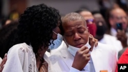 FILE - George Floyd's sisters, Zsa Zsa Floyd and LaTonya Floyd, embrace during the funeral service for their brother at The Fountain of Praise church in Houston, June 9, 2020.