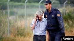 El conductor del tren, José Garzón, según la identificación realizada por los diarios El País y el Mundo de España, al momento de ser retirado del lugar del accidente, ayudado por un policía,