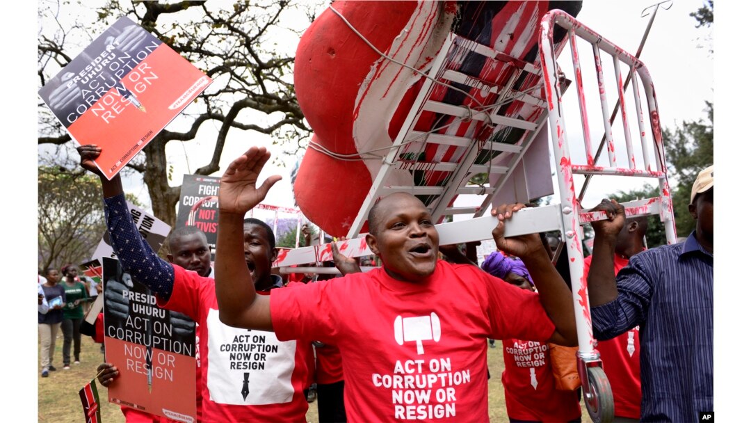 Kenya Corruption: Demonstrators carry a mock hospital bed covered in fake blood to illustrate the slogan that Kenyans are bleeding due to poor hospital services caused by corruption, in Nairobi, Kenya Thursday, Nov. 3, 2016.
