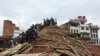 People survey a site damaged by an earthquake, in Kathmandu, Nepal, April 25, 2015.