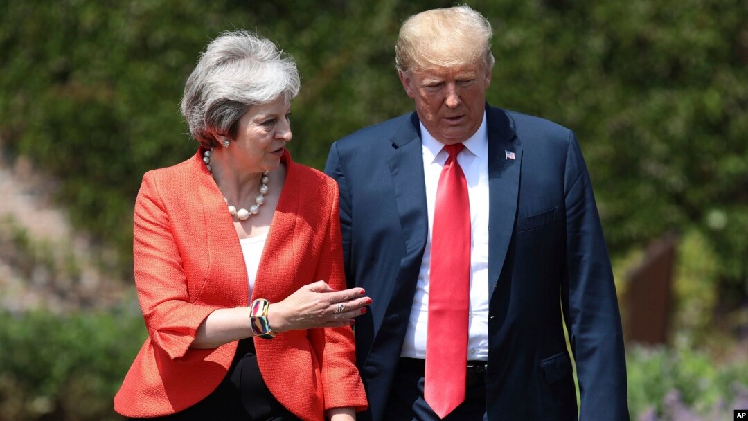 British Prime Minister Theresa May walks with President Donald Trump prior to a joint press conference at Chequers, in Buckinghamshire, England, July 13, 2018.