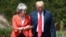 British Prime Minister Theresa May walks with President Donald Trump prior to a joint press conference at Chequers, in Buckinghamshire, England, July 13, 2018.