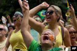 FILE - Demonstrators shout anti-government slogans during a march in March 2015 demanding the impeachment of Brazil's President Dilma Rousseff.