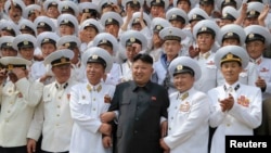 North Korean leader Kim Jong Un (C) poses with officers and sailors of Korean People's Army in Pyongyang June 16, 2014.