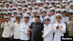 FILE - North Korean leader Kim Jong Un (C) poses with officers and sailors of Korean People's Army in this undated photo released by North Korea's Korean Central News Agency (KCNA) in Pyongyang, June 16, 2014.