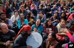 Indian students shout slogans during a protest at the Jawaharlal Nehru University against the arrest of a student union leader in New Delhi, India, Feb. 16, 2016.