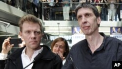 France 3 television journalists Herve Ghesquiere (L) and Stephane Taponier (R) speak during a gathering to celebrate their arrival at France Television headquarters in Paris, June 30, 2011.