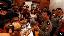 Burma's police chief Zaw Win, second from right, talks to journalists during a press conference regarding recent explosions, Oct 18, 2013, at Rangoon Region government office in Rangoon, Burma. 