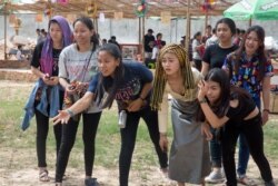 FILE - Young Cambodians are playing traditional Khmer game called Bos Angkunh in Kandal province, Cambodia, on April 7, 2017.