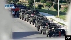 A file photo taken from footage by Sham SNN, a Syrian opposition web channel, shows Syrian army vehicles deployed in the central industrial city of Homs