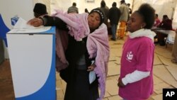 A woman casts her vote at a polling station in Soweto, South Africa, Aug. 3, 2016. A recent report questioned whether Africans still want democracy.