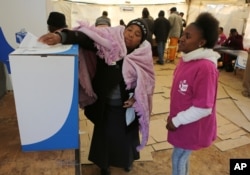 A woman casts her vote at a polling station in Soweto, South Africa, Aug. 3, 2016.