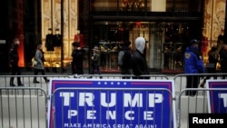 A campaign sign supporting U.S. President-elect Donald Trump and U.S. Vice President-elect Mike Pence is seen in a demonstration area near Trump Tower in the Manhattan borough of New York, Nov. 20, 2016. 
