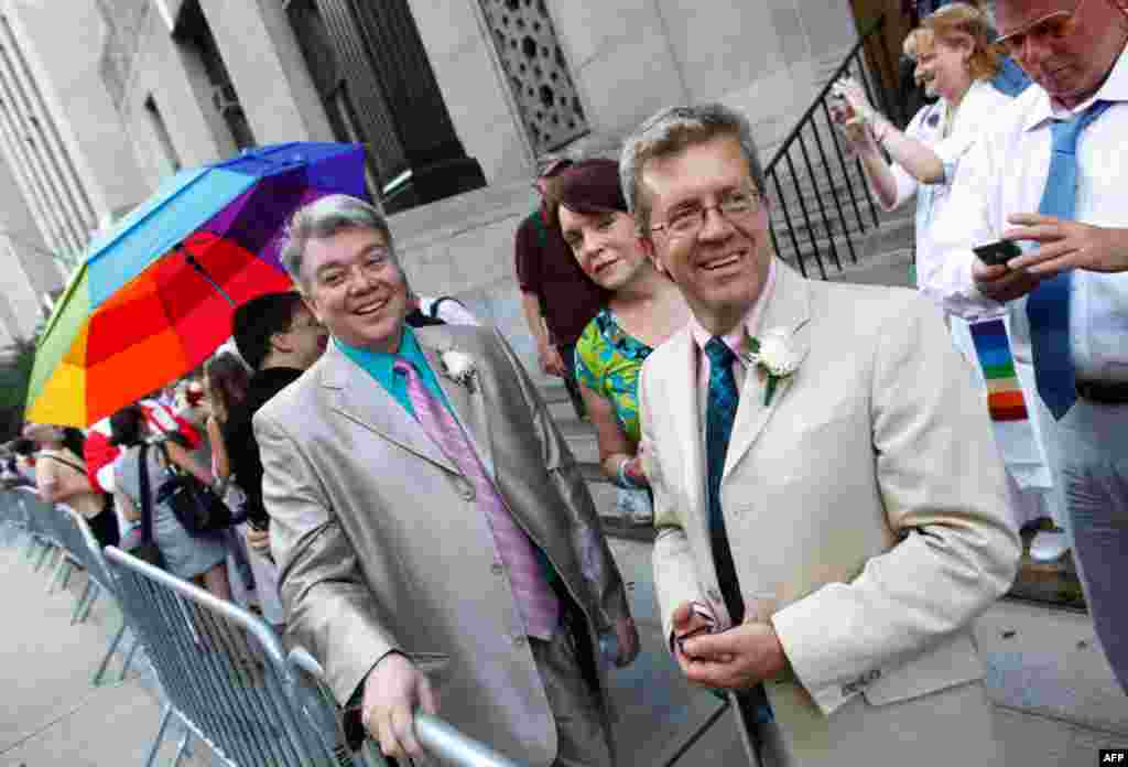 July 24: Richard Skipper, left, and Daniel Sherman, of Sparkill, N.Y., wait to get married at the Manhattan City Clerk's office in New York. (AP Photo/Jason DeCrow)