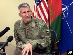 FILE - Gen. John Nicholson, the top American commander in Afghanistan, speaks to reporters, March 14, 2018, at Bagram air base north of Kabul, Afghanistan.