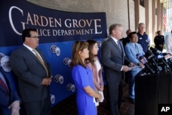 Garden Grove Mayor Steven Jones, fourth from left, speaks during a news conference following the arrest of Zachary Castaneda outside the Garden Grove Police Department headquarters in Garden Grove, Calif., Aug. 8, 2019.