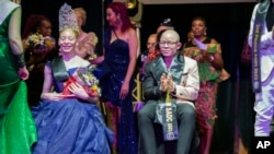 In this photo supplied by pageant organizer John Karimazonde of the Mr. and Miss. Albinism Southern Africa Pageant, the winners Andreia Solange Sicato Muhitu, left, and Ntandoyenkosi Mnkandla are seated, at the Harare International Conference Centre, Saturday Oct. 14, 2023. 