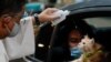 A Catholic priest sprinkles holy water on a cat at a drive-thru pet blessing amid the COVID-19 outbreak on World Animal Day, in Eastwood Mall, Quezon City, Philippines.