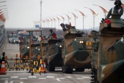 FILE - Amphibious assault vehicles of the South Korean Marine Corps travel during a military exercise as a part of the annual joint military training called Foal Eagle between South Korea and the U.S. in Pohang, South Korea, April 5, 2018.